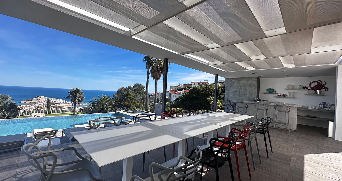 Summer dining area Outdoor dining area with table, chairs and views of the Mediterranean