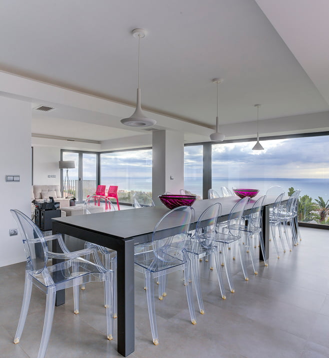 Living room at Villa Atalaya Living room with table and chairs and sea views
