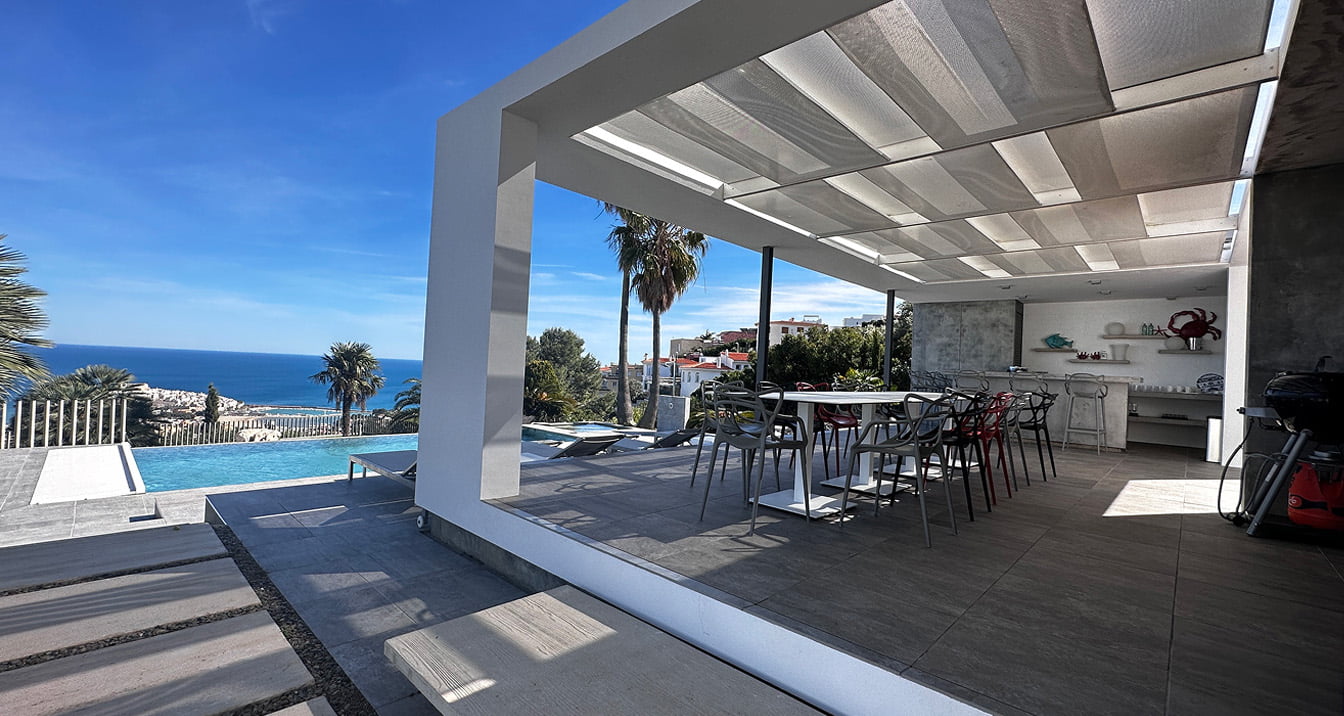 Villa Atalaya outdoor dining area Outdoor dining area with swimming pool, table and chairs