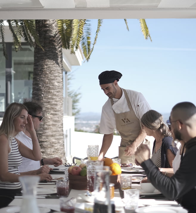 Private chef service Chef serving breakfast at the table