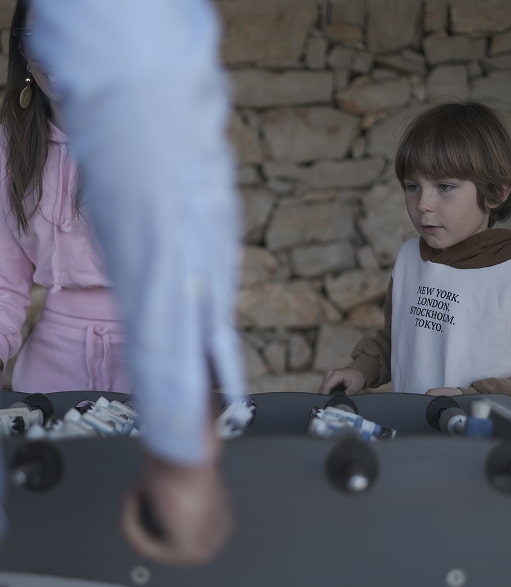 Outdoor games area Children playing table football in the games area